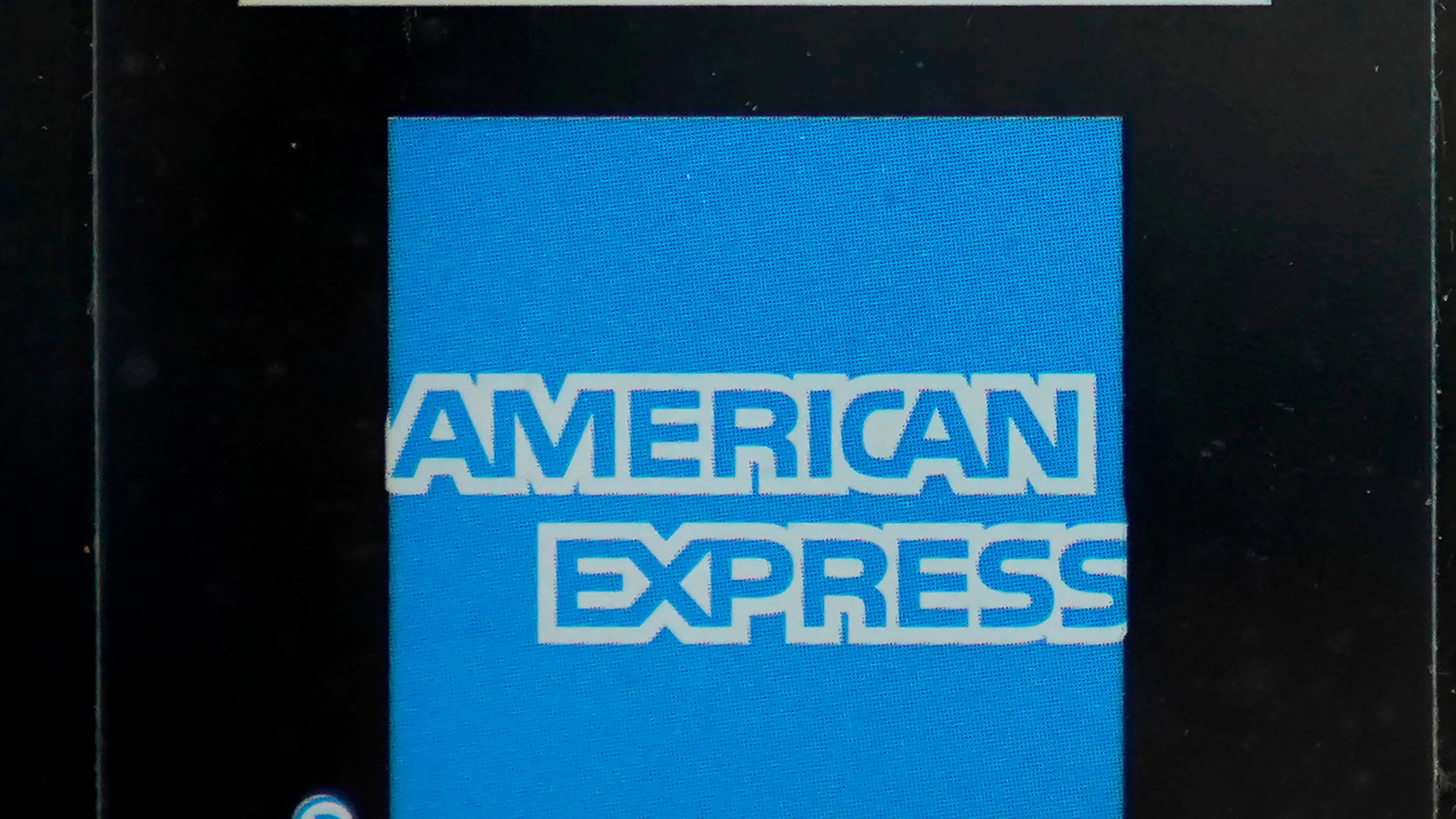FILE - An American Express logo is attached to a door in Boston's Seaport District, July 21, 2021. (AP Photo/Steven Senne, File)