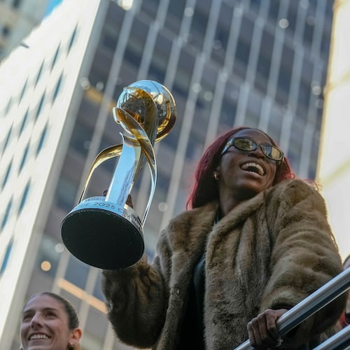 Gotham Football Club captain Mandy Freeman holds up the NWSL championship trophy as she rides down Broadway with the team during a parade celebrating their win over the Washington Spirit, Monday, Nov. 24, 2025, in New York. (Michael Appleton/New York City Mayor's Office via AP)