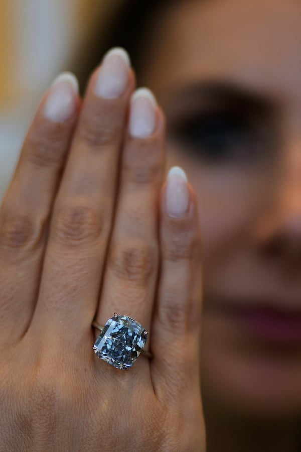 Sotheby's Deputy Chairman, Middle East & Head of Sotheby's UAE, Katia Noun Boueiz wears the Mediterranean Blue diamond during its worldwide debut in Abu Dhabi, United Arab Emirates, Tuesday, April 8, 2025. (AP Photo/Altaf Qadri)