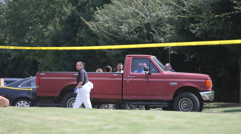 Kennesaw police are investigating a body found inside of a red pickup truck in the 1700 block of Waterside Drive. BEN GRAY/BGRAY@AJC.COM