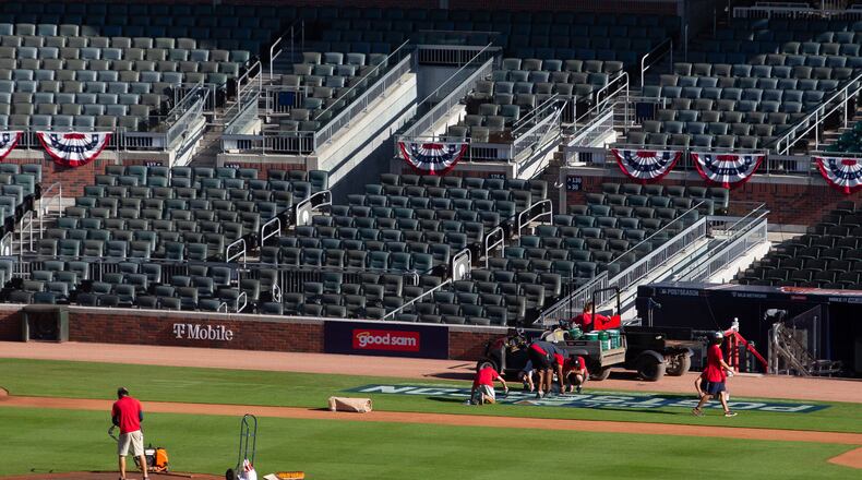 The infield at Truist Park is being readied on Sunday, Oct. 10, 2021, for Monday's Game 3 of NLDS series between the Atlanta Braves and Milwaukee Brewers in Atlanta. The series is tied 1-1. (Steve Schaeffer/For the AJC)