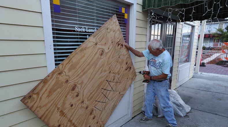 September 5, 2019 St. Mary's, Georgia: Local resident and business owner Jimmy Mock returns to his general store taking the boards down to begin moving merchandise back in and reopening the business after Hurricane Dorian on Thursday, Sept. 5, 2019, at St. Mary's. Mock appeared to have escaped with minor wind damage.   Curtis Compton/ccompton@ajc.com
