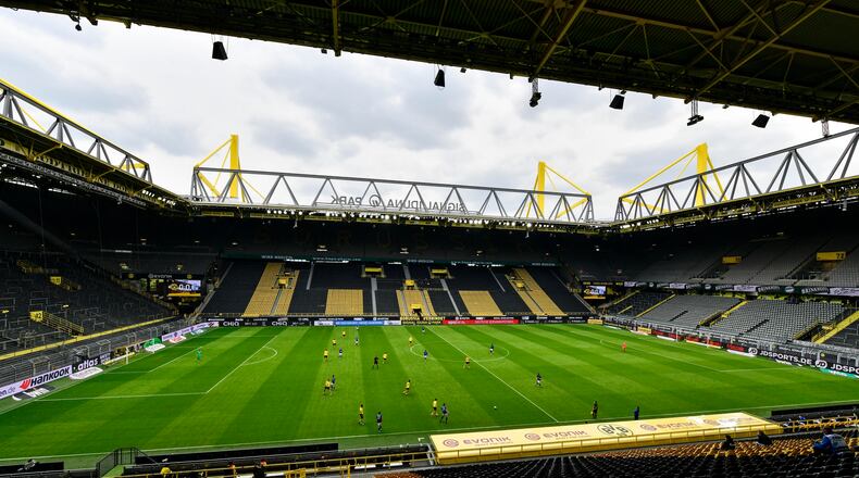 Empty seats are seen in the Signal Iduna Park without spectators during the German Bundesliga soccer match between Borussia Dortmund and Schalke 04 in Dortmund, Germany, Saturday, May 16, 2020. The German Bundesliga becomes the world's first major soccer league to resume after a two-month suspension because of the coronavirus pandemic. (AP Photo/Heinz Buese, Pool)
