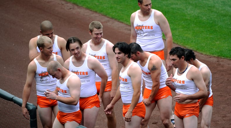 Rookie members of the San Diego Padres baseball team are dressed like Hooters restaurant workers, as part of rookie hazing after the Padres' 1-0 loss to the Colorado Rockies in a baseball game at Coors Field in Denver.