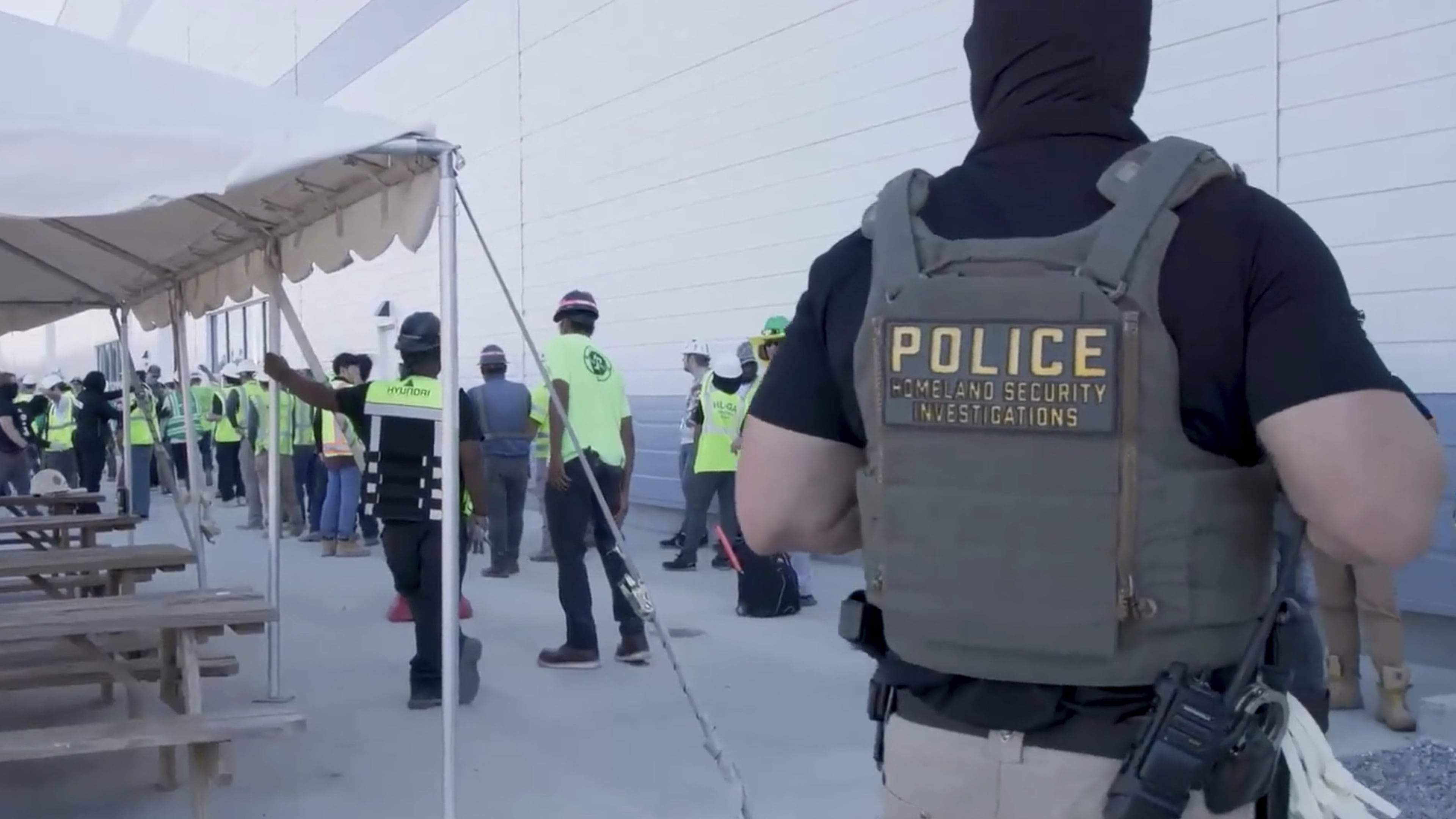 Manufacturing plant employees are escorted out of the Hyundai Motor Group’s electric vehicle plant, Thursday, Sept. 4, 2025, in Ellabell, Ga. (Corey Bullard/U.S. Immigration and Customs Enforcement via AP)