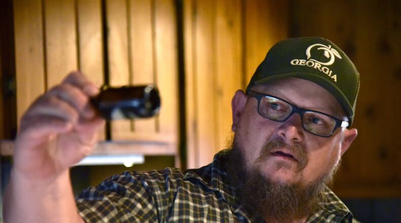 Jim “J-Bo” Wages holds a bottle of cannabis oil for her daughter Sydney at their home in Dallas on Wednesday, February 8, 2017. The family was among the very first to receive permission from Georgia to use low-dose cannabis oil without fear of prosecution. HYOSUB SHIN / HSHIN@AJC.COM