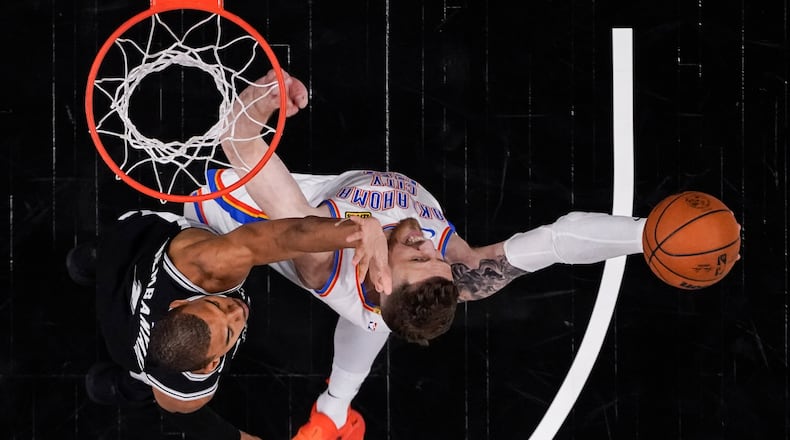 Oklahoma City Thunder center Isaiah Hartenstein (55) shoots against San Antonio Spurs forward Victor Wembanyama (1) in the second half of Game 6 in the Western Conference finals NBA basketball playoffs series, Thursday, May 28, 2026, in San Antonio. (AP Photo/David J. Phillip)