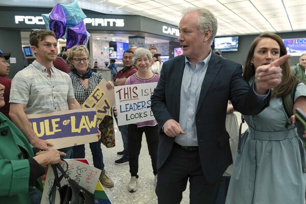 Sen. Chris Van Hollen, D-Md., is welcomed by supporters upon his arrival from meeting with Kilmar Abrego Garcia in El Salvador, at Washington Dulles International Airport, in Chantilly, Va., Friday, April 18, 2025. (AP Photo/Jose Luis Magana)