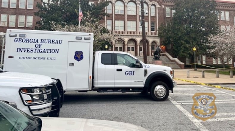 A GBI vehicle is parked in front of Booker T. Washington High School, where an Atlanta Public Schools police officer shot a parent who was allegedly brandishing a gun outside the building Wednesday.
