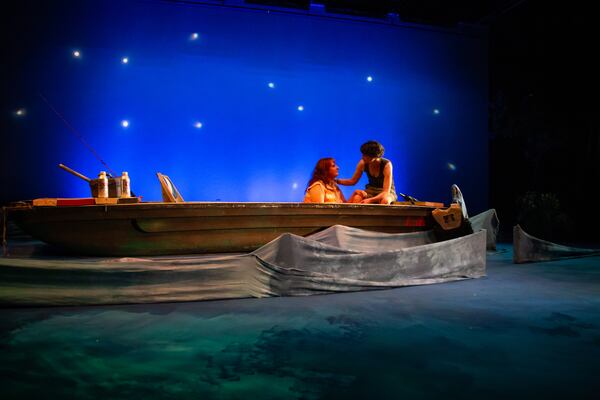 The “wicked yet whimsical set by Sof Delgado allow one’s mind to imagine the alligators and snakes lurking just beneath the surface of the painted waterway,” writes critic Alexis Hauk.