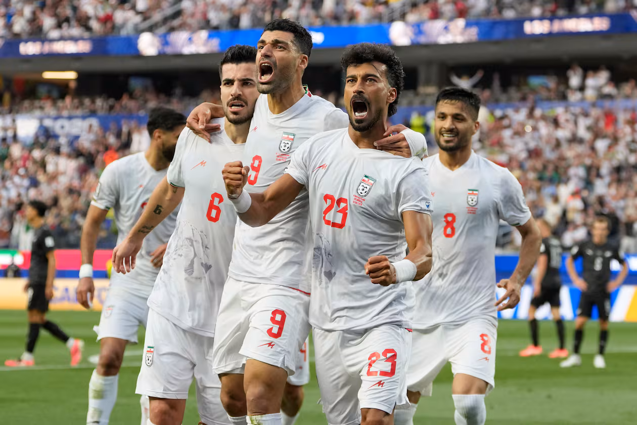 Iran's Ramin Rezaeian (23) celebrates with his teammates after scoring a goal during the World Cup Group G soccer match between Iran and New Zealand in Inglewood, Calif., near Los Angeles, Monday, June 15, 2026. (AP Photo/Andre Penner)