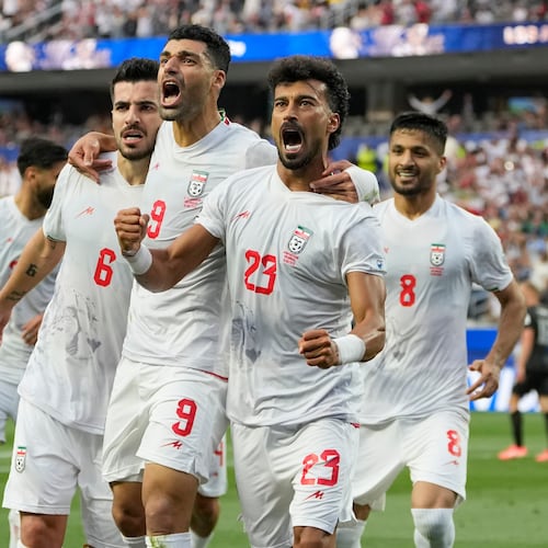 Iran's Ramin Rezaeian (23) celebrates with his teammates after scoring a goal during the World Cup Group G soccer match between Iran and New Zealand in Inglewood, Calif., near Los Angeles, Monday, June 15, 2026. (AP Photo/Andre Penner)