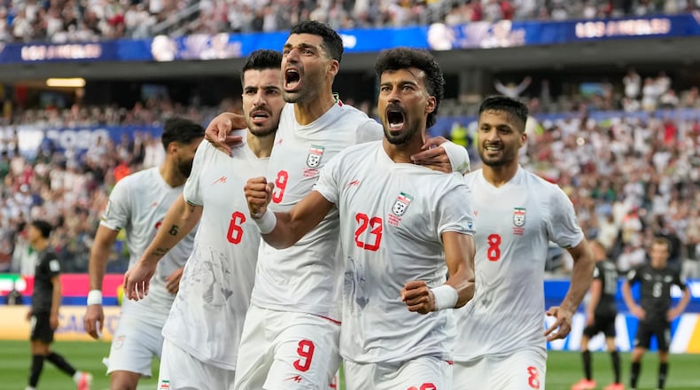 Iran's Ramin Rezaeian (23) celebrates with his teammates after scoring a goal during the World Cup Group G soccer match between Iran and New Zealand in Inglewood, Calif., near Los Angeles, Monday, June 15, 2026. (AP Photo/Andre Penner)