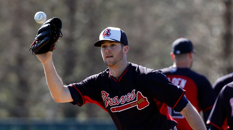 Atlanta Braves pitcher Alex Wood prepares to field a ball during a spring training baseball workout, Tuesday, Feb. 18, 2014, in Kissimmee, Fla. (AP Photo/Alex Brandon)