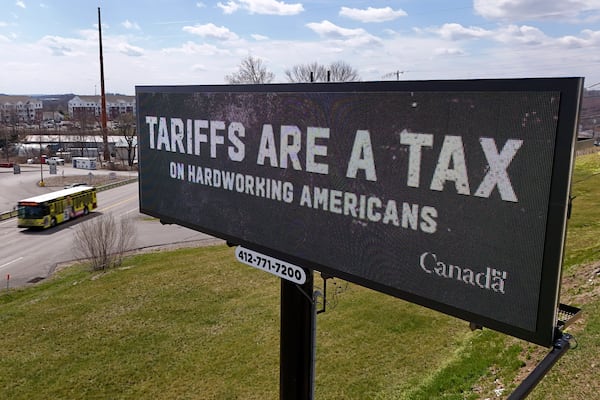 FILE - A digital bill board flashes a tariffs message in Kennedy Township, Pa., Tuesday, March 25, 2025. (AP Photo/Gene J. Puskar, file)