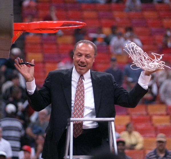 Coach Lenny Wilkins cuts down the net after the Hawks played their final regular season game in The Omni in 1997. (JONATHAN NEWTON/staff)