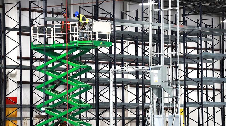 Construction has been the state’s fastest-growing sector. Here in Jonesboro, workers assemble industrial storage shelving inside the massive new LTI Inc., food service equipment manufacturer building. Curtis Compton/ccompton@ajc.com