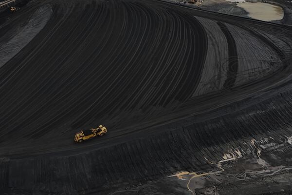 Heavy equipment moves through coal at the Gen. James Gavin Power Plant, a coal-fired power plant, Monday, April 14, 2025, in Cheshire, Ohio. (AP Photo/Joshua A. Bickel)