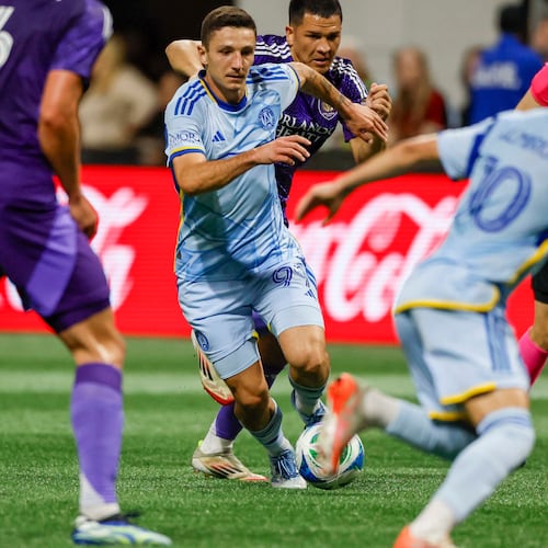 Atlanta United midfielder Bartosz Slisz (center) — pictured dribbling in traffic against Orlando City in May — was sold to Brøndby for $3.5 million. (Miguel Martinez/AJC 2025)