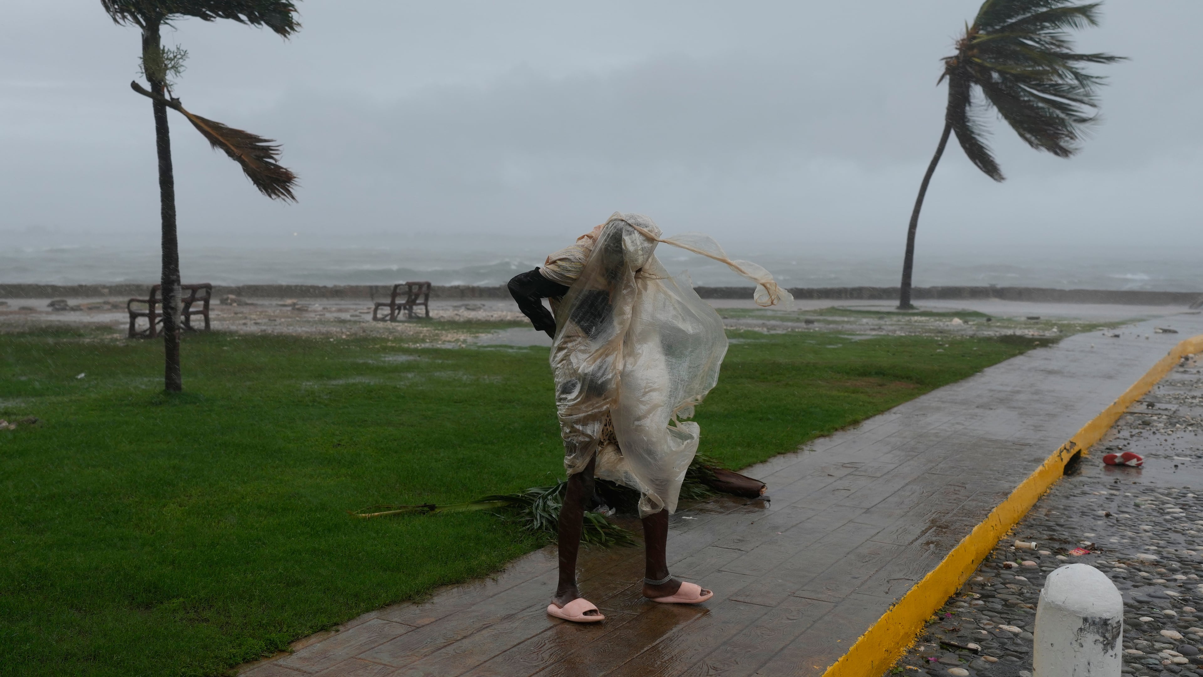 A man walks in Kingston, Jamaica, as Hurricane Melissa approaches, Tuesday, Oct. 28, 2025. (AP Photo/Matias Delacroix)
