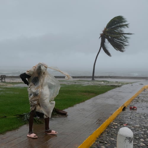 A man walks in Kingston, Jamaica, as Hurricane Melissa approaches, Tuesday, Oct. 28, 2025. (AP Photo/Matias Delacroix)