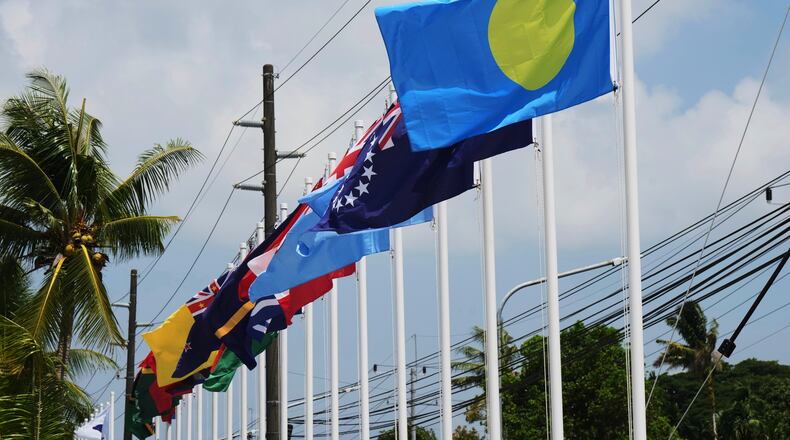 Flags of member states fly outside the summit venue for the Pacific Islands Forum Leaders Meeting in Koror, Palau, Sunday, Aug. 30, 2026. (AP Photo/Charlotte Graham-McLay)