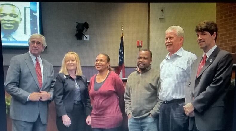 Marietta Mayor Steve Tumlin, far left, and City Manager Bill Bruton, far right, congratulate city employees during a recognition ceremony. All city employees have received salary increases of at least 3 percent this year. Courtesy of Marietta