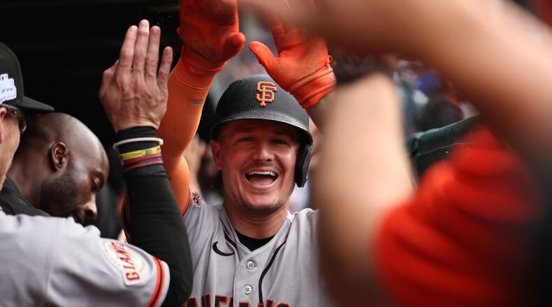 The San Francisco Giants' Matt Chapman celebrates in the dugout after hitting a grand slam during the fourth inning of a baseball game against the Chicago Cubs, Friday, June 5, 2026, in Chicago. (AP Photo/Geoff Stellfox)