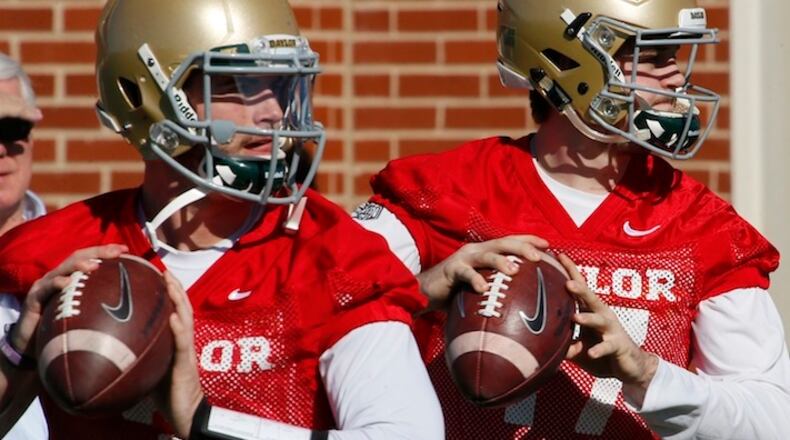 Baylor quarterbacks Jarrett Stidham, left, and Seth Russell, right, throw during the first day of spring football drills, Thursday, Feb. 25, 2016, in Waco, Texas. (Rod Aydelotte/Waco Tribune Herald via AP) MANDATORY CREDIT