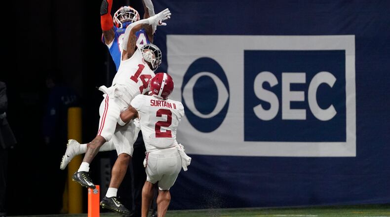 Florida tight end Kyle Pitts (84) makes a touchdown catch against Alabama defensive back Brian Branch (14) during the second half of the Southeastern Conference championship NCAA college football game, Saturday, Dec. 19, 2020, in Atlanta. (AP Photo/John Bazemore)