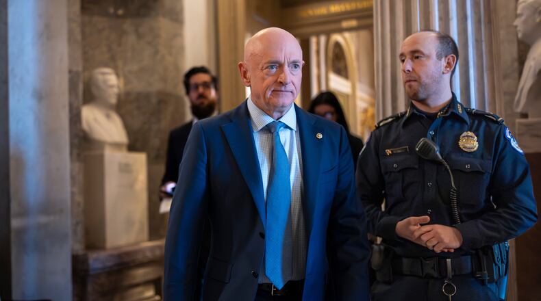 Sen. Mark Kelly, D-Ariz., exits the Senate chamber after speaking out against Defense Secretary Pete Hegseth's efforts to censure him over his participation in a video that called on troops to resist unlawful orders, at the Capitol in Washington, Monday, Jan. 12, 2026. (AP Photo/J. Scott Applewhite)