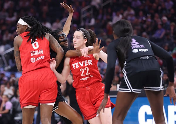 Golden State Valkyries' Tiffany Hayes, second from left, tries to defend against Indiana Fever's Caitlin Clark (22) through a screen by Fever's Natasha Howard (6) in the first quarter of a WNBA basketball game in San Francisco, Thursday, June 19, 2025. (Scott Strazzante/San Francisco Chronicle via AP)
