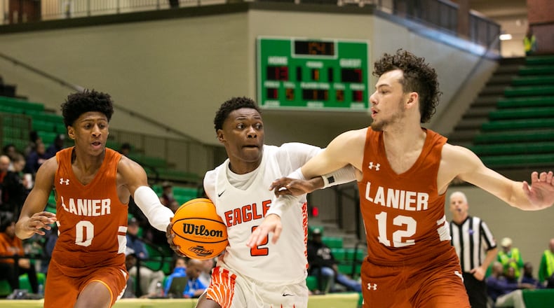 South Cobb guard Shedrick Williams (2) pushes past Lanier guard Mason Friedel (12) and Lanier point guard Andrew mcConnell (0) during a GHSA basketball game between Lanier and South Cobb at Buford City Arena in Buford, Georgia, on Friday, February 28, 2020. (Photo/Rebecca Wright for the AJC)