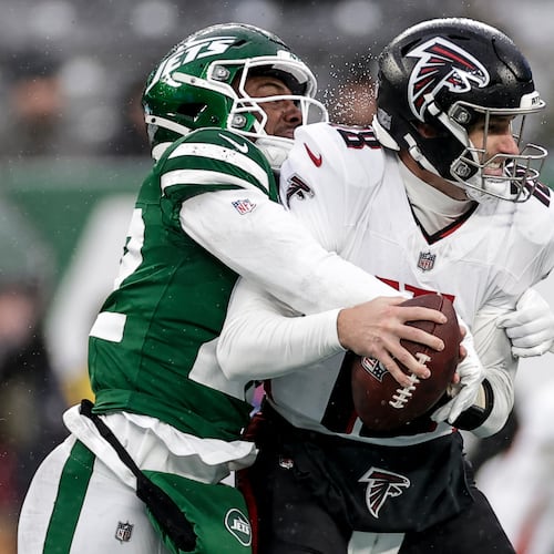 New York Jets safety Tony Adams (22) sacks Atlanta Falcons quarterback Kirk Cousins (18) during the first half of an NFL football game, Sunday, Nov. 30, 2025, in East Rutherford, N.J. (AP Photo/Adam Hunger)
