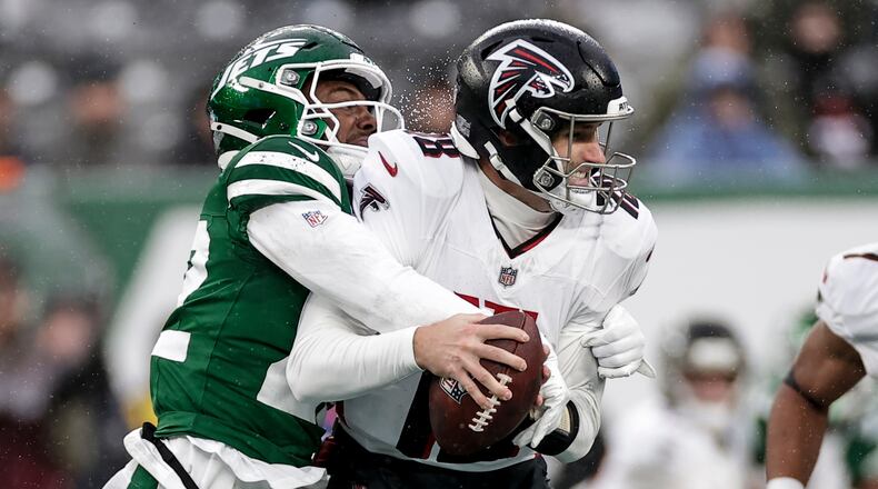 New York Jets safety Tony Adams (22) sacks Atlanta Falcons quarterback Kirk Cousins (18) during the first half of an NFL football game, Sunday, Nov. 30, 2025, in East Rutherford, N.J. (AP Photo/Adam Hunger)