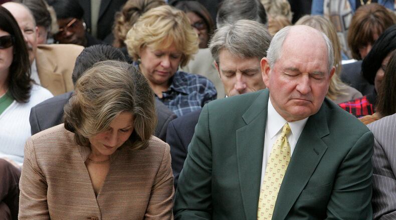 Georgia Gov. Sonny Perdue and his wife Mary pray during a prayer service for rain on the steps of the Capitol Tuesday, Nov. 13, 2007. "We've come together here simply for one reason and one reason only: To very reverently and respectfully pray up a storm," Perdue said. The state's appeal to God for rain showers came as Georgia is mired in an epic drought, threatening the region's water supply. (AP Photo/John Bazemore)