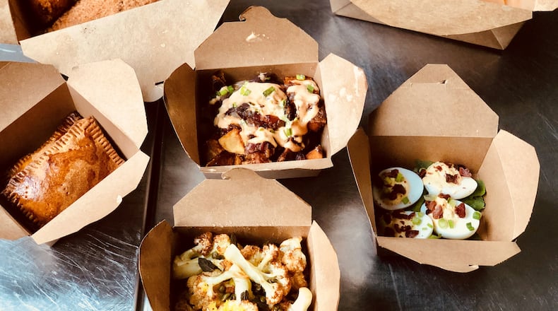 Full Commission in Grant Park offers stellar takeout. Shown here (clockwise from top left): fried catfish, jambalaya, deviled eggs, cauliflower, Jamaican beef patties and "animal-style" home fries (with bacon-onion jam and special sauce). CONTRIBUTED BY WENDELL BROCK