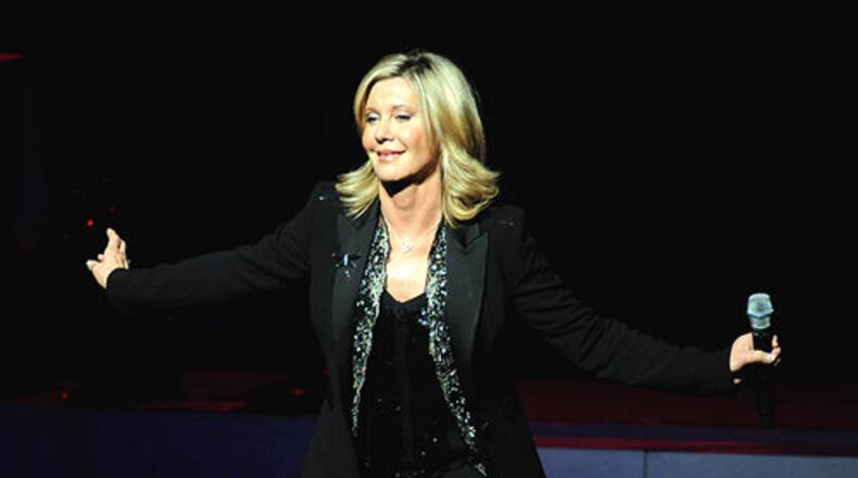 Olivia Newton-John was appointed as an Officer of the Order of Australia by Queen Elizabeth for her philanthropic work with organizations supporting the environment and breast cancer research. Newton-John was born in Cambridge, England, but grew up in Australia. (AJC File)