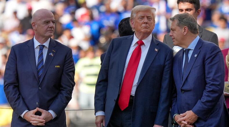 FILE - President Donald Trump, center, talks with Chelsea football club owner Todd Boehly, right, as FIFA president Gianni Infantino, left, looks on before the trophy ceremony of the Club World Cup final soccer match in East Rutherford, N.J., Sunday, July 13, 2025. (AP Photo/Frank Franklin II, File)