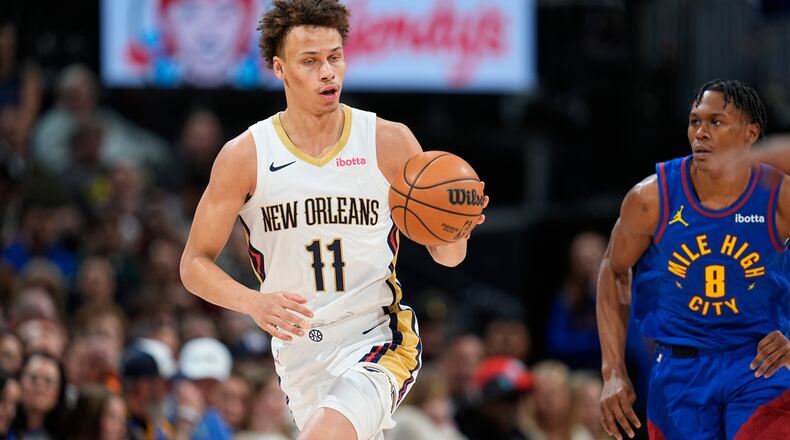 New Orleans Pelicans guard Dyson Daniels, left, pulls in a loose ball as Denver Nuggets forward Peyton Watson pursues in the second half of an NBA basketball game Friday, Jan. 12, 2024, in Denver. (AP Photo/David Zalubowski)