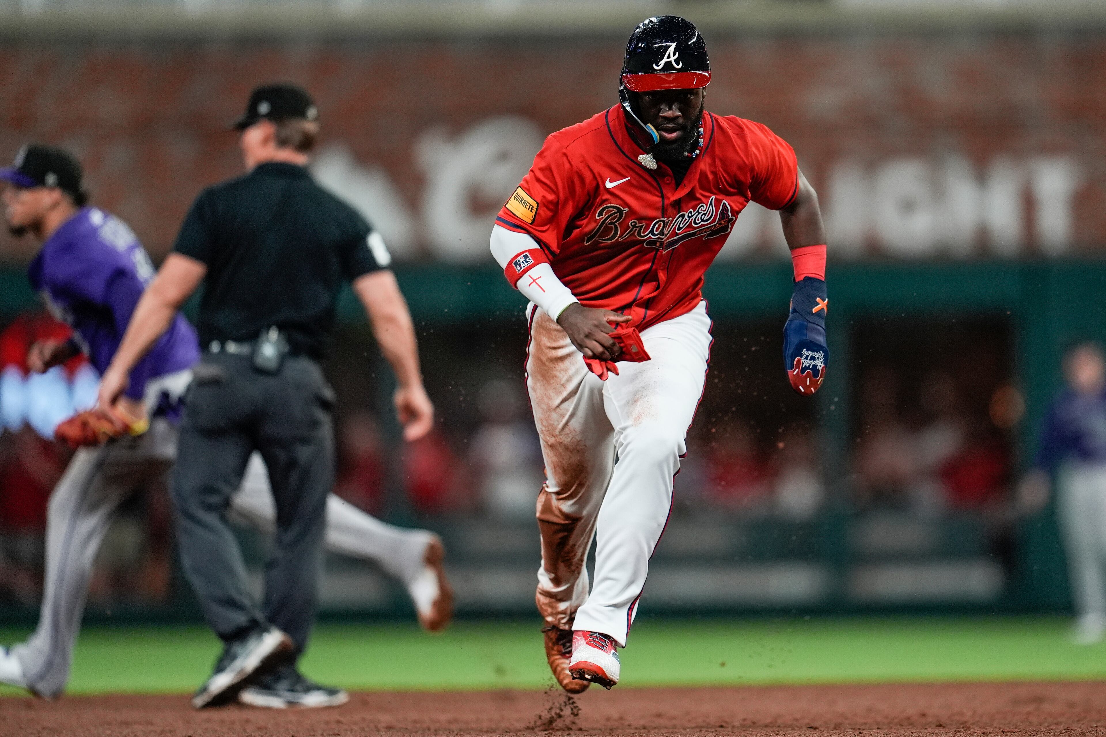 Braves center fielder Michael Harris II runs to third against the Colorado Rockies on a loose ball during the eighth inning on Friday in Atlanta. (Mike Stewart/AP)