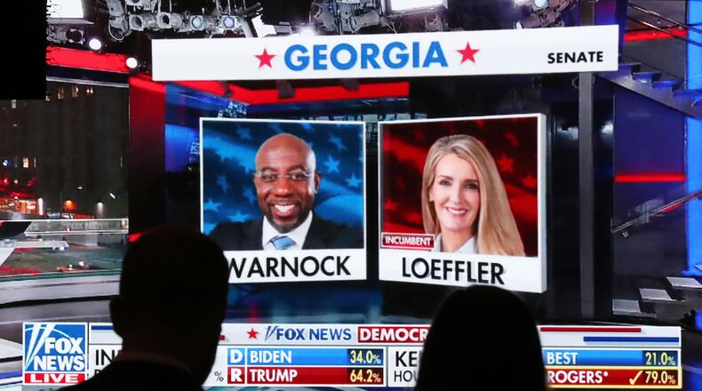 Republican supporters watch returns for Democratic U.S. Senate candidate Raphael Warnock and Republican incumbent Kelly Loeffler come in at the Georgia Republican Party Election Night Celebration Party at the Intercontinental Buckhead Atlanta hotel on Tuesday, Nov. 3, 2020, in Atlanta. (Curtis Compton/Atlanta Journal-Constitution/TNS)