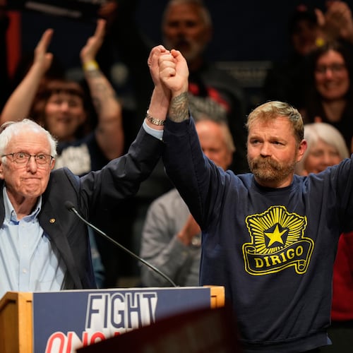 Graham Platner, Democratic candidate for U.S. Senate, and Sen. Bernie Sanders, left, join hands at an event in Orono, Maine, Sunday, May 24, 2026. (AP Photo/Robert F. Bukaty)