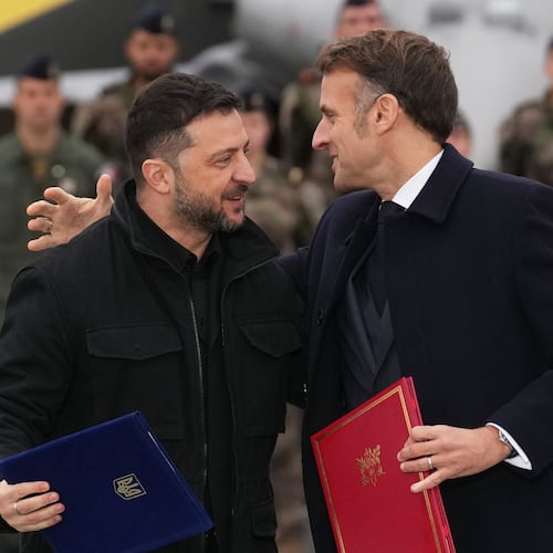 French President Emmanuel Macron, right, and Ukrainian President Volodymyr Zelenskyy hug after signing an agreement Monday, Nov. 17, 2025 at the Villacoublay air base near Paris. (AP Photo/Christophe Ena, Pool)