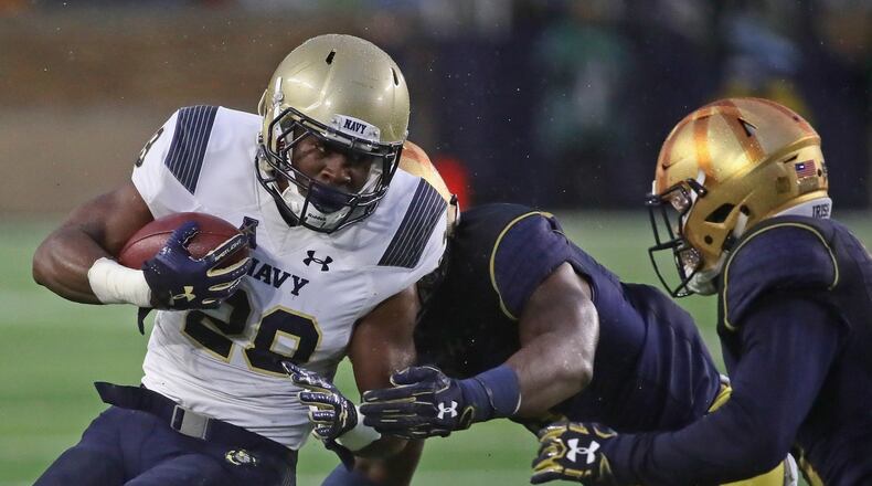Josh Brown of Navy is hit by Daelin Hayes (center) and Shaun Crawford of Notre Dame at Notre Dame Stadium on November 18, 2017 in South Bend, Indiana. (Photo by Jonathan Daniel/Getty Images)