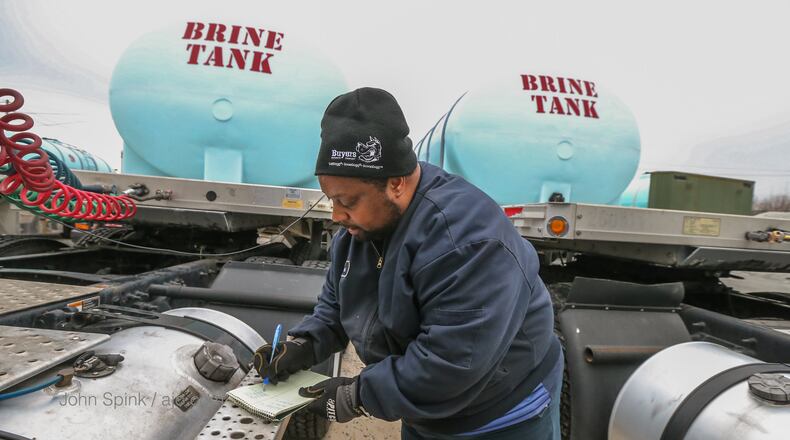 Randy Walker walks by 19 brine tanks at the Georgia Department of Transportation facility on Kennedy Drive in Forest Park.