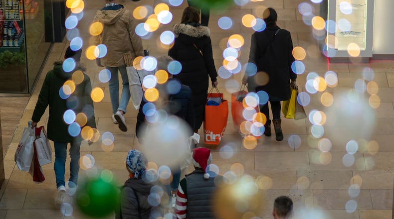 BIRMINGHAM, ENGLAND - DECEMBER 24: Shoppers make their last minute purchases on Christmas Eve on December 24, 2018 in Birmingham, England. Financial management consultancy Deloitte has predicted larger than normal discounts for boxing day sales as retailers aim to recuperate sales after a weak lead up to Chrismas. (Photo by Christopher Furlong/Getty Images)