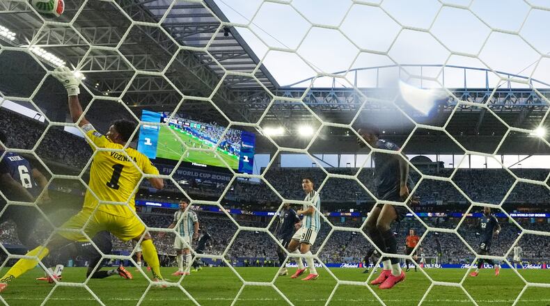 Cape Verde goalkeeper Vozinha (1) is scored on by Argentina's Lisandro Martinez during the World Cup round of 32 soccer match between Argentina and Cape Verde in Miami Gardens, Fla., Friday, July 3, 2026. (AP Photo/Lynne Sladky)