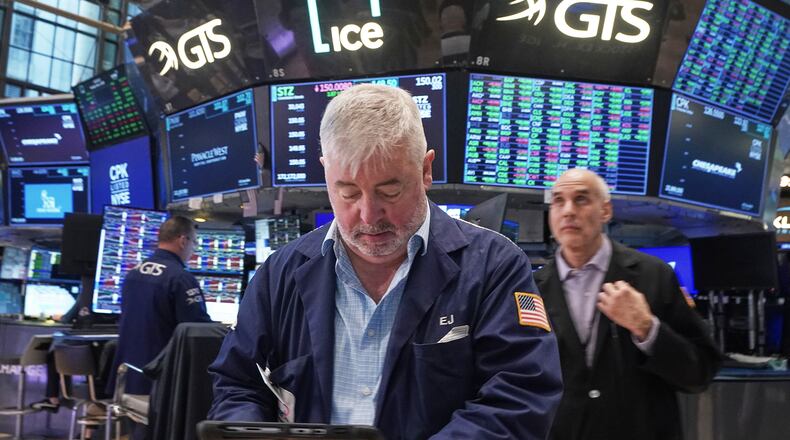 Trader Edward McCarthy, center, works on the floor of the New York Stock Exchange, Tuesday, May 5, 2026. (AP Photo/Richard Drew)