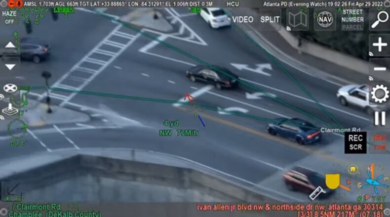 A Dodge Charger (center) speeds through a busy intersection along Clairmont Road in Chamblee during an April 29 police chase.